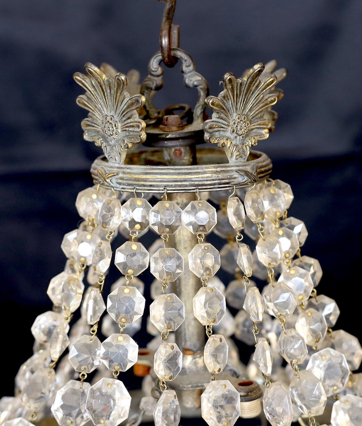 An early 20th century bronze and beaded crystal bag shaped chandelier with graduated octagonal cut drops, height 50cm. width 30 cm